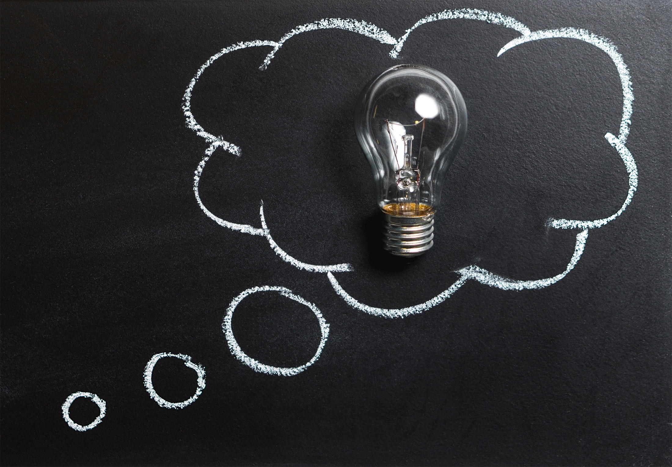 A thought bubble surrounding a lightbulb