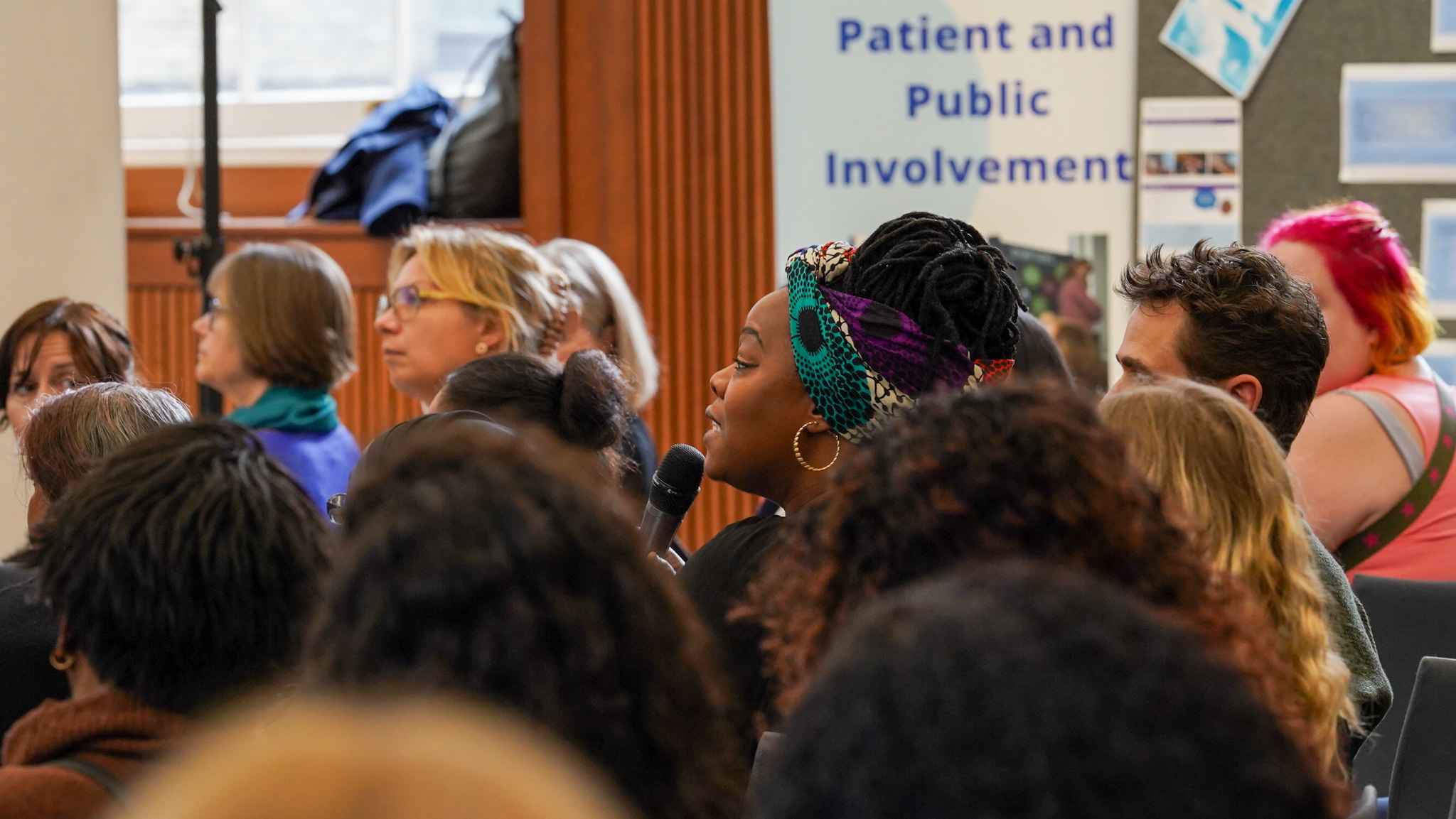 Audience member speaking into a microphone at a public involvement event